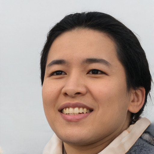 Joyful asian young-adult female with medium  black hair and brown eyes