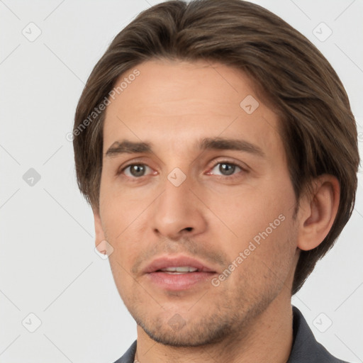 Joyful white young-adult male with short  brown hair and grey eyes