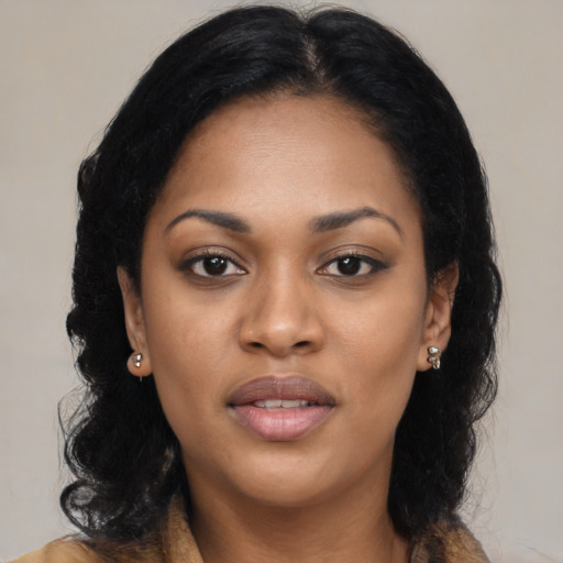 Joyful black young-adult female with long  black hair and brown eyes