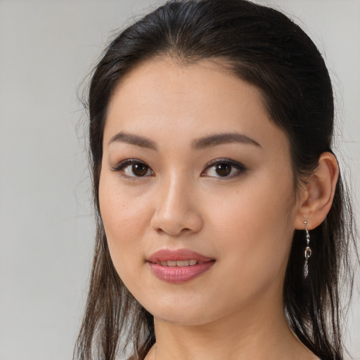 Joyful white young-adult female with long  brown hair and brown eyes