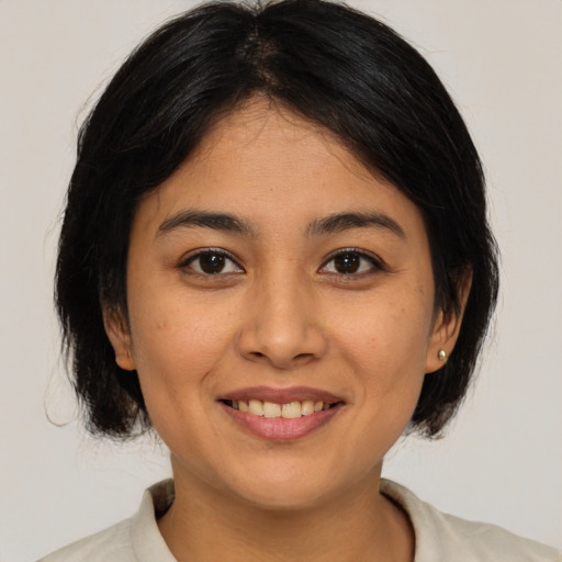 Joyful asian young-adult female with medium  brown hair and brown eyes