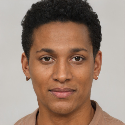 Joyful black young-adult male with short  black hair and brown eyes