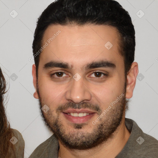 Joyful white young-adult male with short  black hair and brown eyes