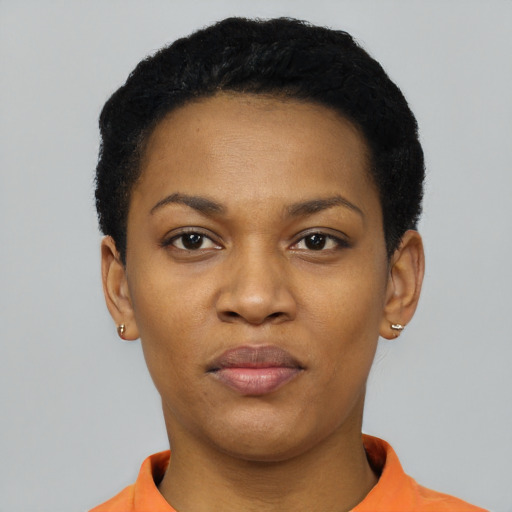 Joyful black young-adult female with short  black hair and brown eyes