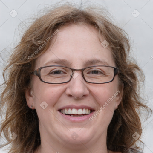 Joyful white adult female with medium  brown hair and blue eyes