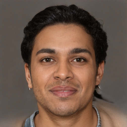 Joyful latino young-adult male with short  brown hair and brown eyes