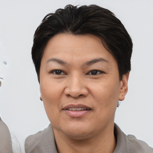 Joyful asian adult female with short  brown hair and brown eyes