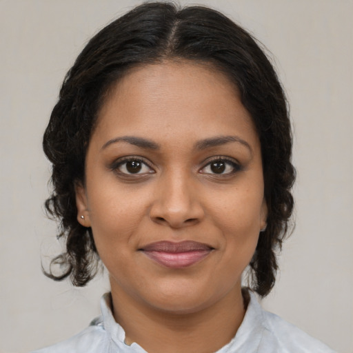 Joyful black young-adult female with medium  brown hair and brown eyes