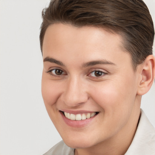 Joyful white young-adult female with short  brown hair and brown eyes