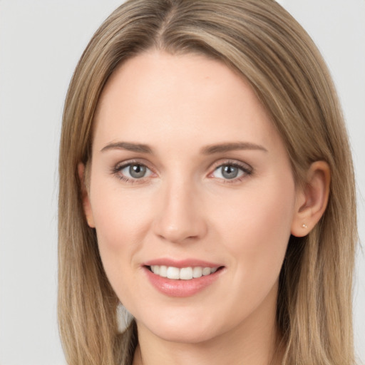 Joyful white young-adult female with long  brown hair and green eyes