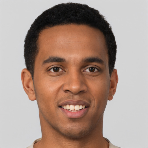 Joyful black young-adult male with short  black hair and brown eyes