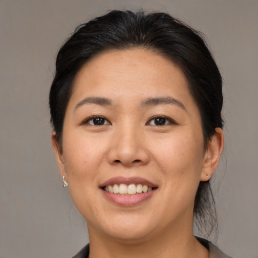 Joyful asian young-adult female with medium  brown hair and brown eyes
