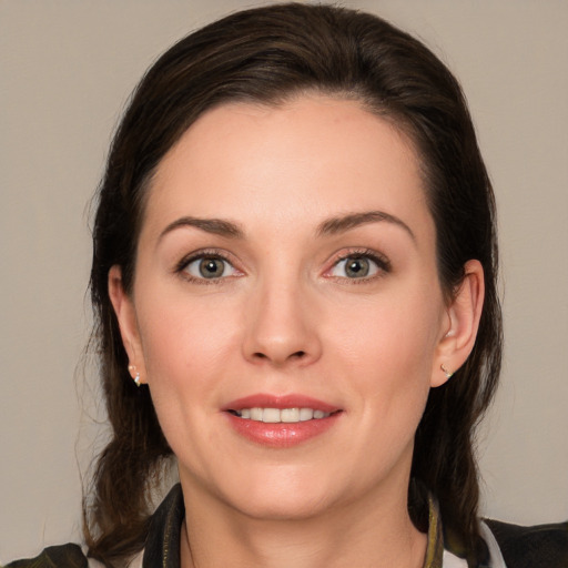 Joyful white young-adult female with medium  brown hair and brown eyes