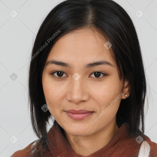 Joyful latino young-adult female with medium  brown hair and brown eyes