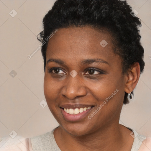 Joyful black young-adult female with short  black hair and brown eyes