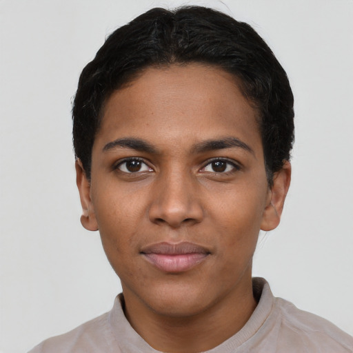 Joyful black young-adult female with short  black hair and brown eyes