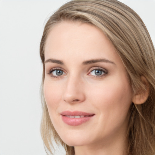 Joyful white young-adult female with long  brown hair and blue eyes