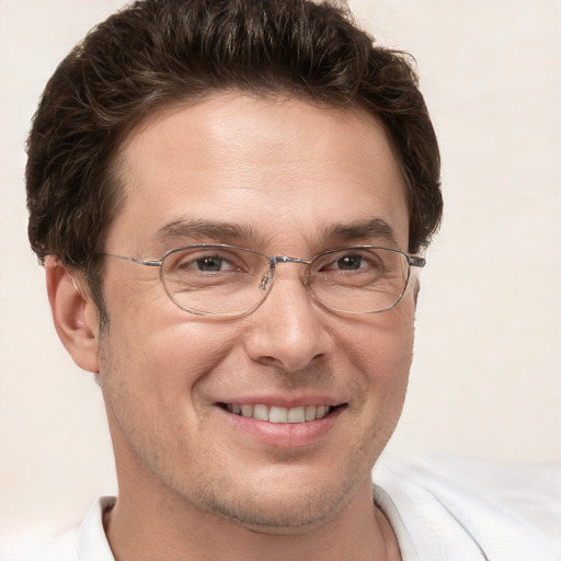 Joyful white adult male with short  brown hair and brown eyes