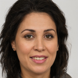 Joyful white adult female with long  brown hair and brown eyes