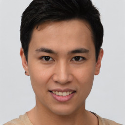 Joyful asian young-adult male with short  brown hair and brown eyes