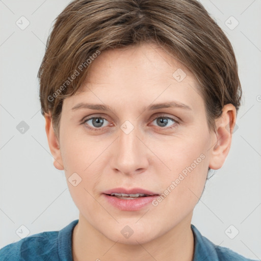 Joyful white young-adult female with short  brown hair and grey eyes