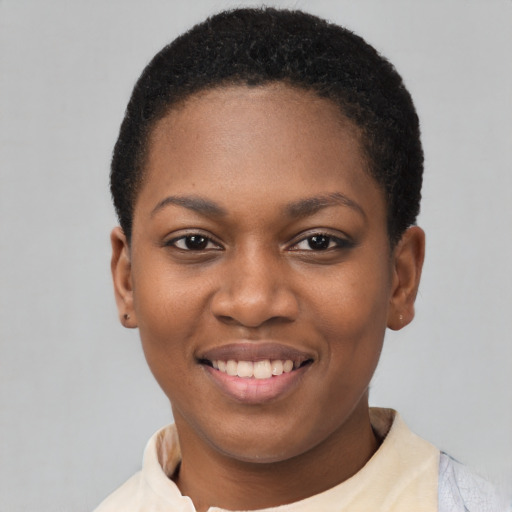 Joyful black young-adult female with short  black hair and brown eyes