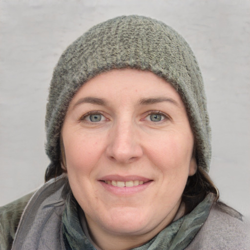 Joyful white adult female with short  brown hair and grey eyes