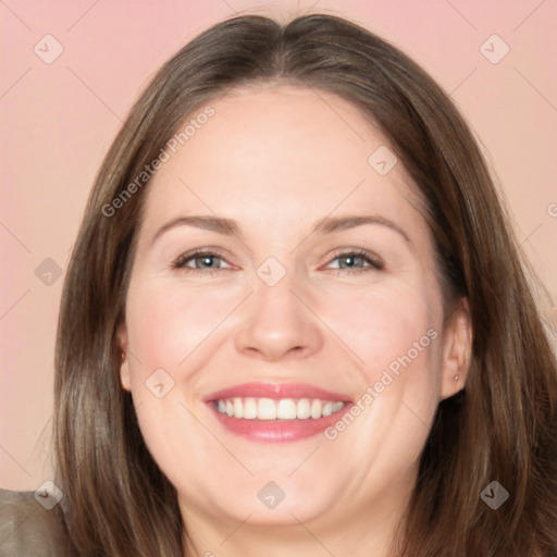 Joyful white adult female with long  brown hair and brown eyes