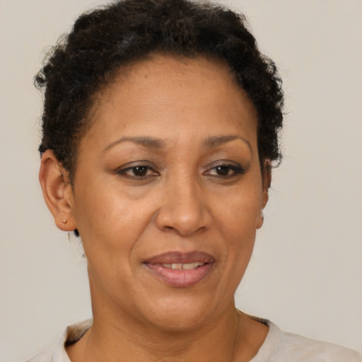 Joyful black adult female with short  brown hair and brown eyes