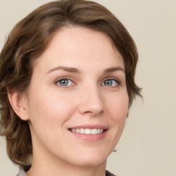 Joyful white young-adult female with medium  brown hair and green eyes