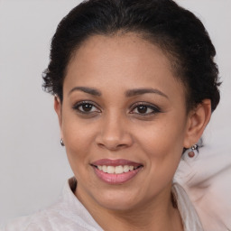 Joyful latino young-adult female with medium  brown hair and brown eyes