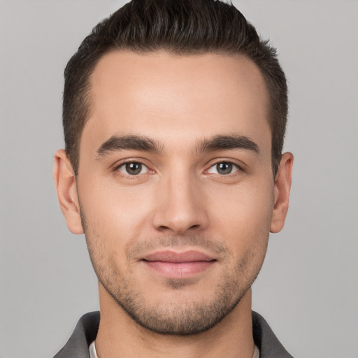 Joyful white young-adult male with short  brown hair and brown eyes