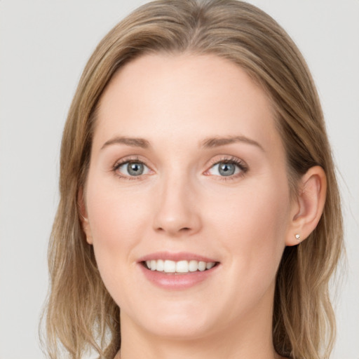 Joyful white young-adult female with long  brown hair and blue eyes