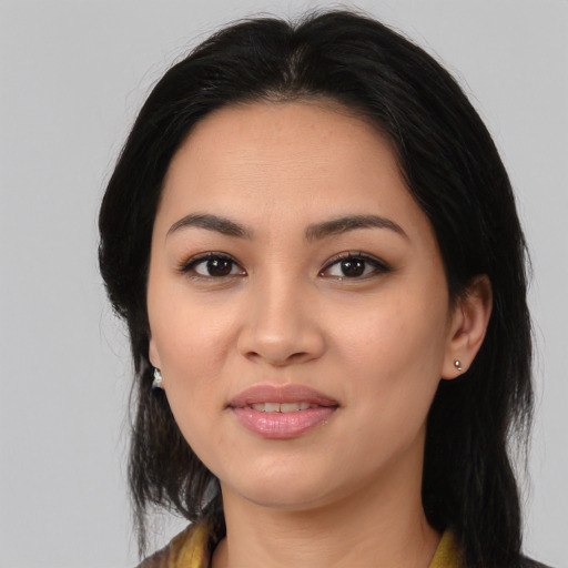 Joyful latino young-adult female with medium  black hair and brown eyes
