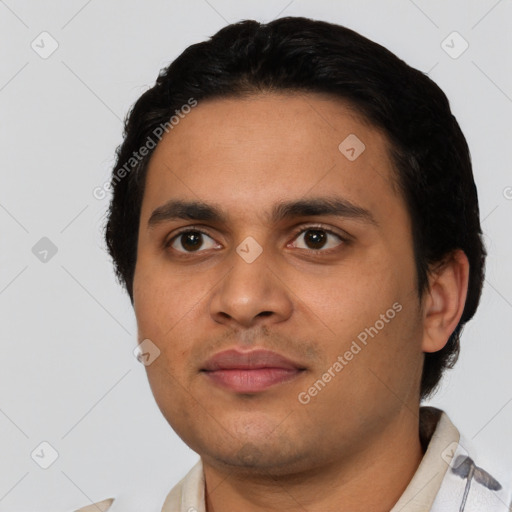 Joyful latino young-adult male with short  black hair and brown eyes