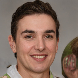 Joyful white adult male with short  brown hair and brown eyes