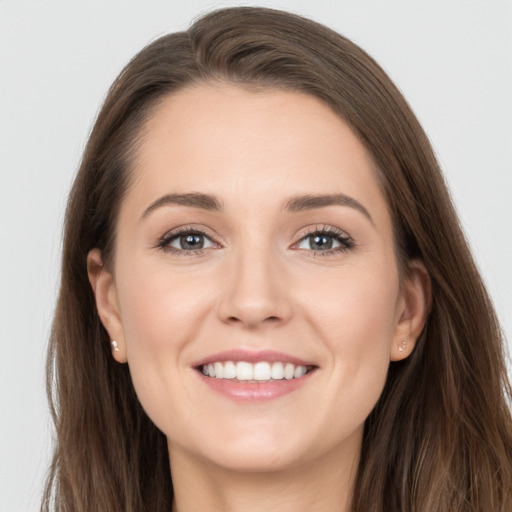 Joyful white young-adult female with long  brown hair and grey eyes