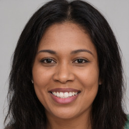 Joyful latino young-adult female with long  brown hair and brown eyes