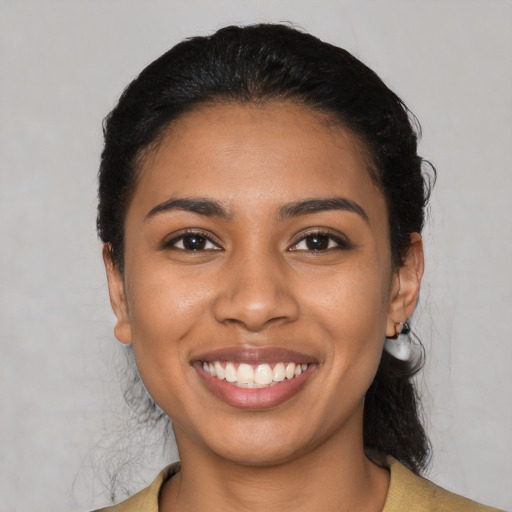 Joyful latino young-adult female with medium  black hair and brown eyes