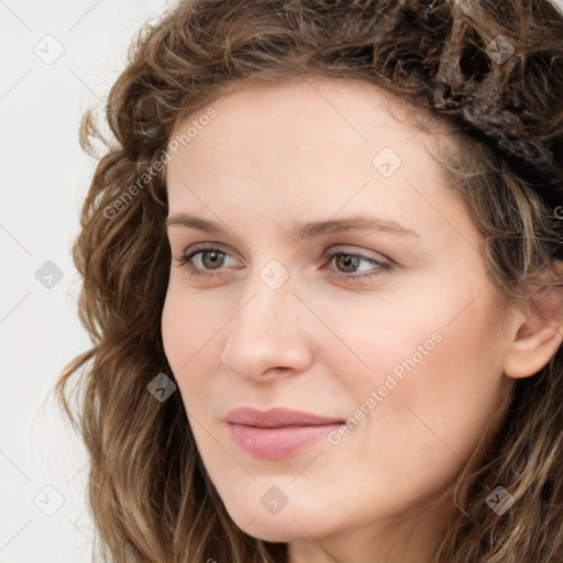 Joyful white young-adult female with long  brown hair and green eyes