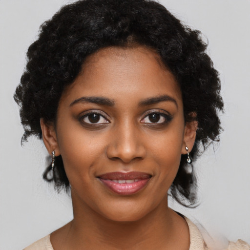 Joyful black young-adult female with medium  black hair and brown eyes