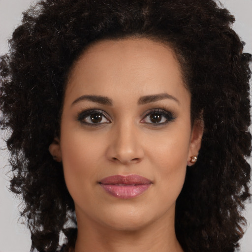 Joyful latino young-adult female with medium  brown hair and brown eyes