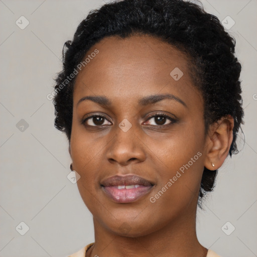 Joyful black young-adult female with short  black hair and brown eyes