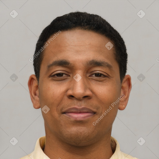 Joyful latino young-adult male with short  black hair and brown eyes