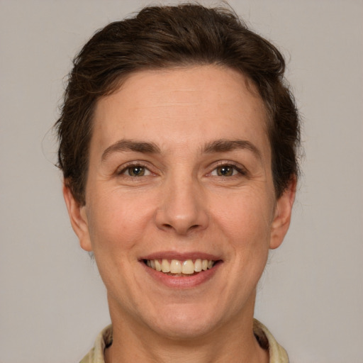 Joyful white adult female with short  brown hair and grey eyes