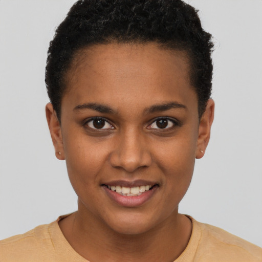 Joyful black young-adult female with short  brown hair and brown eyes