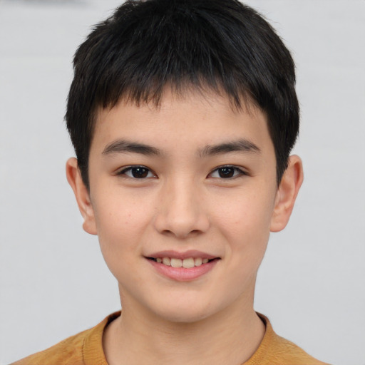 Joyful asian child male with short  brown hair and brown eyes