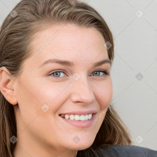 Joyful white young-adult female with long  brown hair and blue eyes