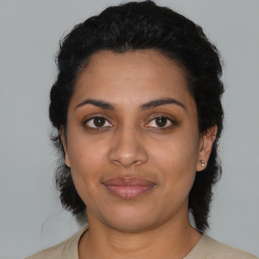 Joyful latino young-adult female with short  black hair and brown eyes