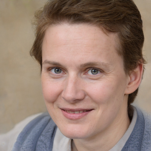 Joyful white young-adult female with medium  brown hair and blue eyes